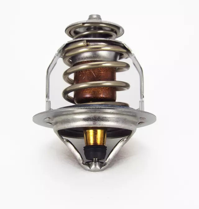 Automotive coolant thermostat featuring circular metal housing and smooth exterior finish