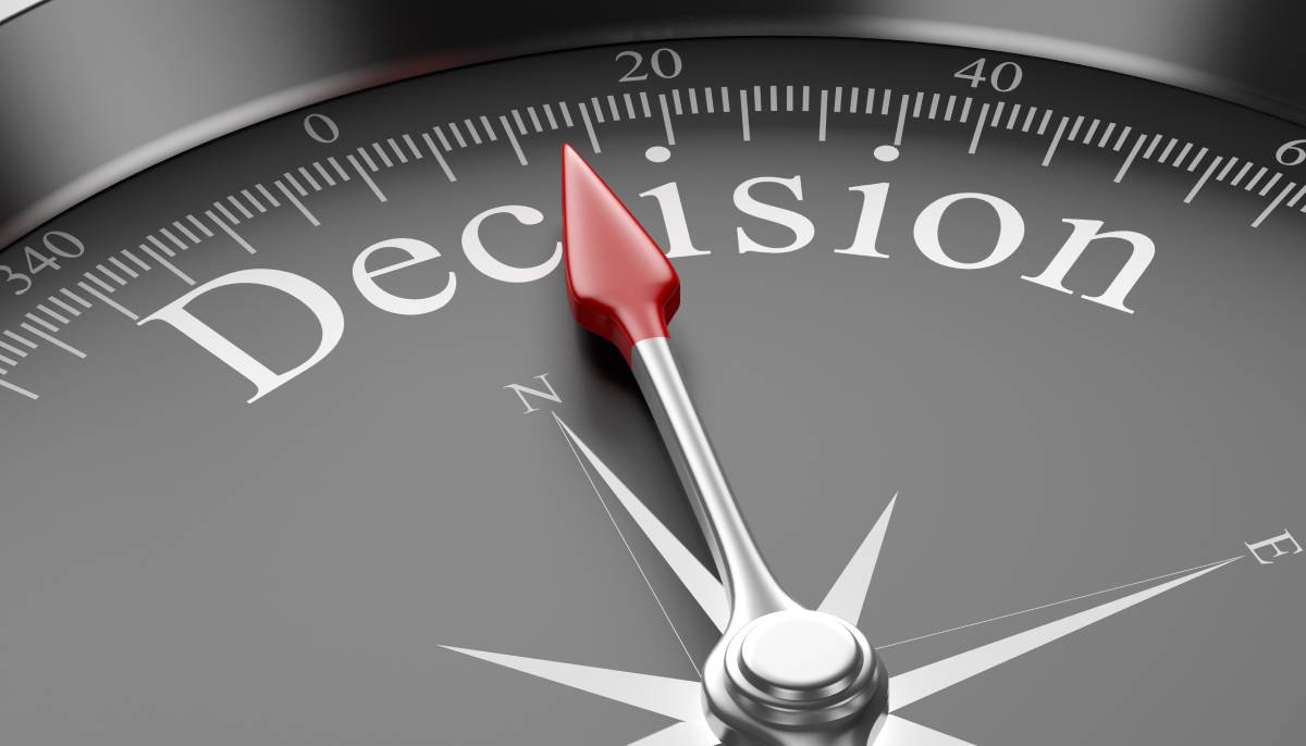Compass needle pointing toward the word “Decision,” symbolizing strategic choices and long-term business direction.