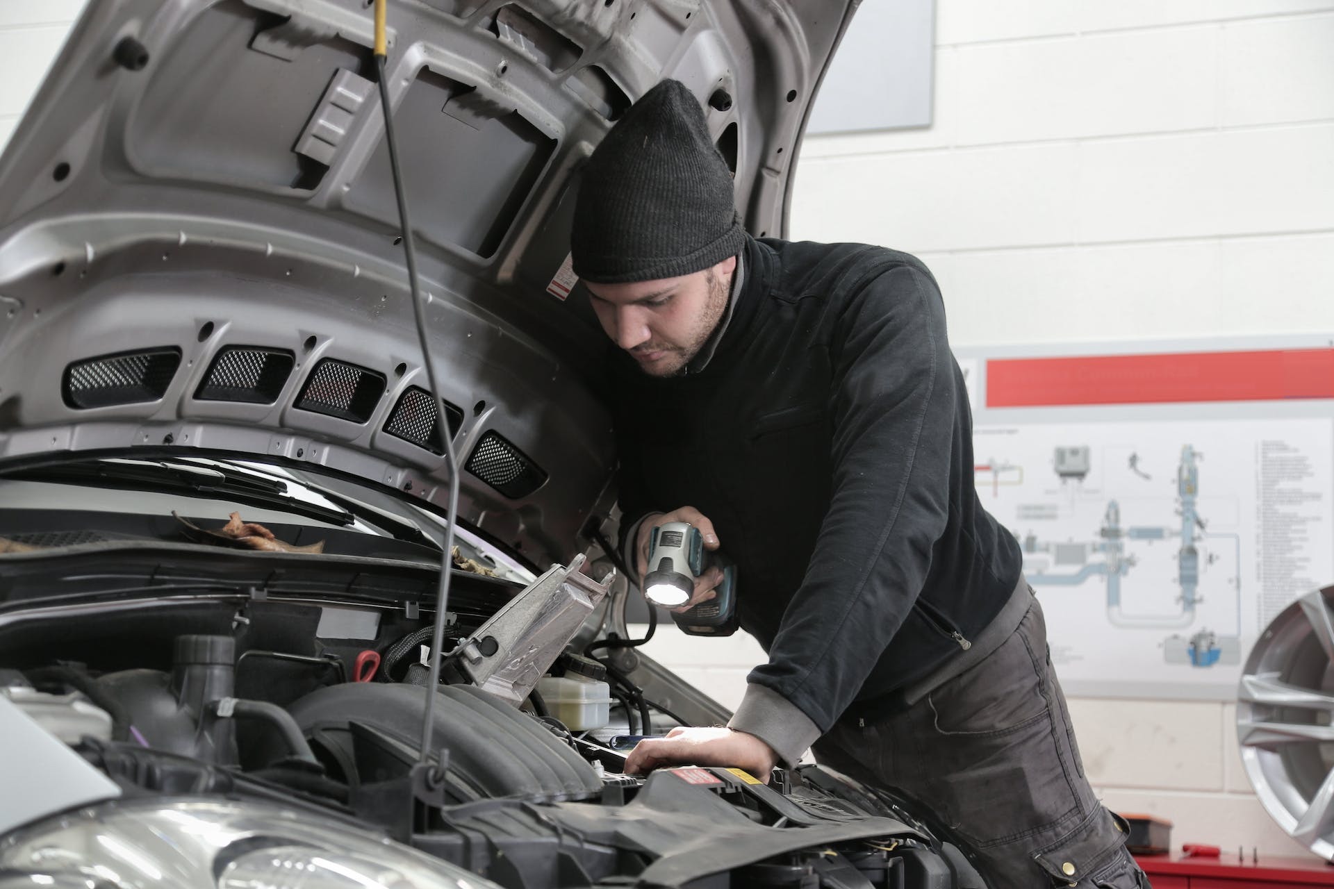 A mechanic replacing a fuel filter on a Ford F450 Super Duty, emphasizing professional maintenance and reliable parts supply.